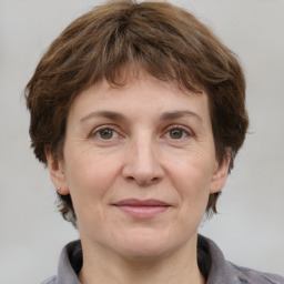 Joyful white adult female with medium  brown hair and grey eyes