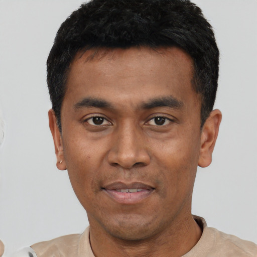 Joyful asian young-adult male with short  black hair and brown eyes