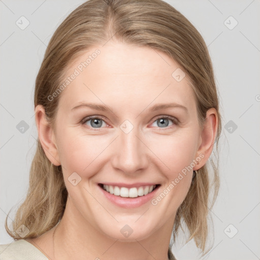 Joyful white young-adult female with medium  brown hair and blue eyes