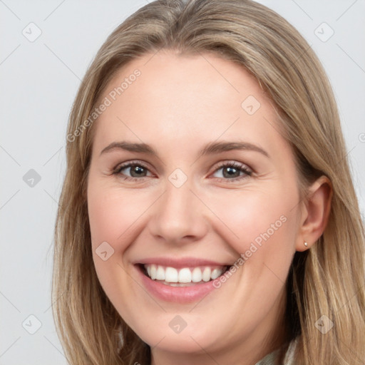 Joyful white young-adult female with long  brown hair and brown eyes