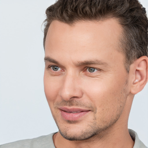 Joyful white young-adult male with short  brown hair and brown eyes