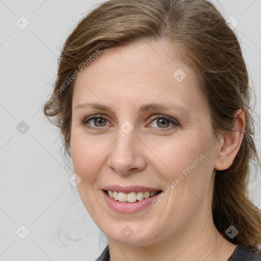 Joyful white young-adult female with medium  brown hair and grey eyes