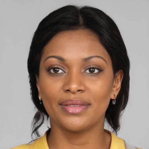 Joyful black young-adult female with medium  black hair and brown eyes