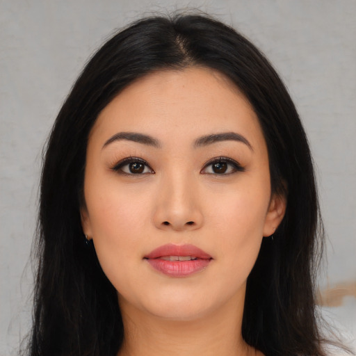 Joyful asian young-adult female with long  black hair and brown eyes