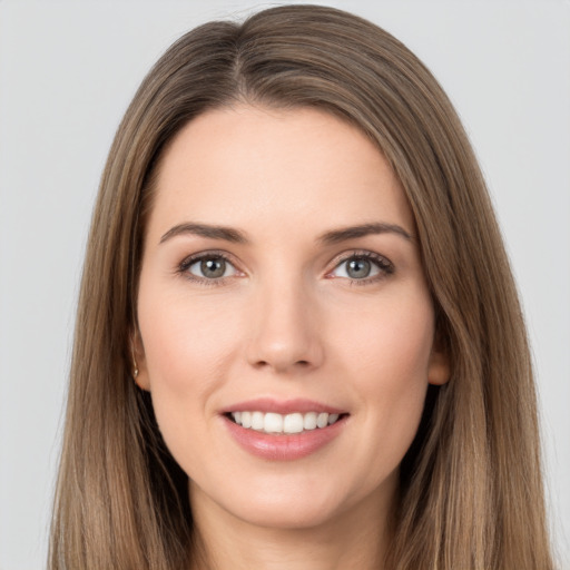 Joyful white young-adult female with long  brown hair and brown eyes