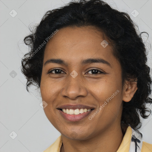 Joyful black young-adult female with long  brown hair and brown eyes