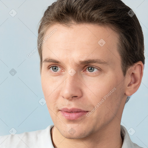 Joyful white adult male with short  brown hair and grey eyes