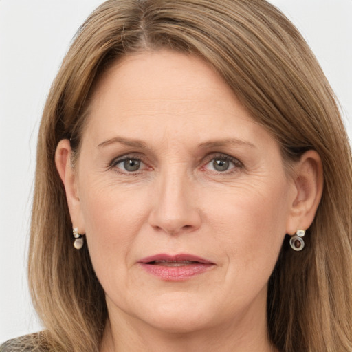 Joyful white adult female with long  brown hair and grey eyes