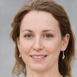 Joyful white young-adult female with medium  brown hair and green eyes