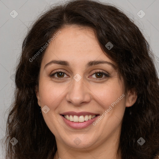 Joyful white adult female with long  brown hair and brown eyes