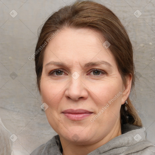 Joyful white adult female with medium  brown hair and brown eyes