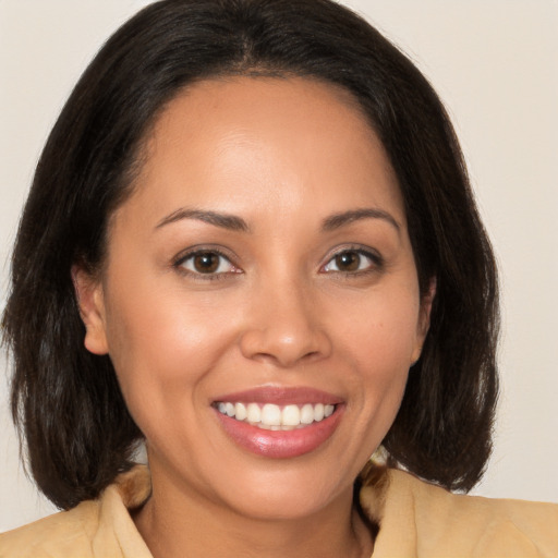 Joyful white young-adult female with medium  brown hair and brown eyes