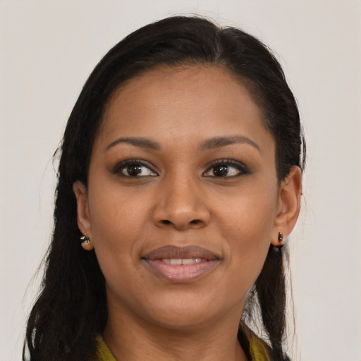 Joyful black young-adult female with long  brown hair and brown eyes