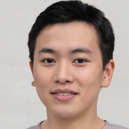 Joyful asian young-adult male with short  black hair and brown eyes