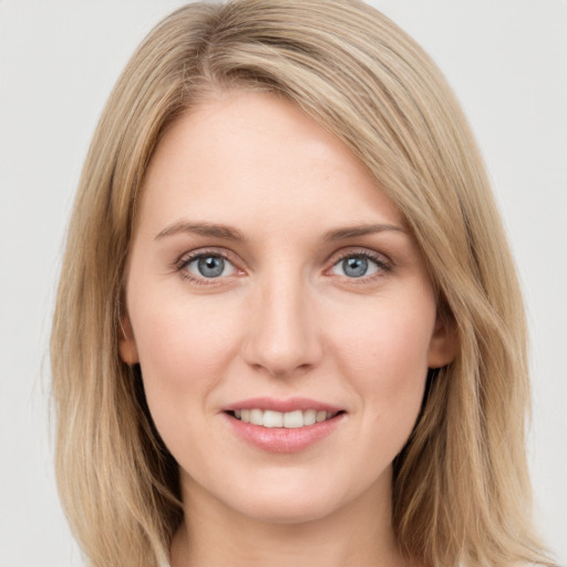 Joyful white young-adult female with long  brown hair and blue eyes