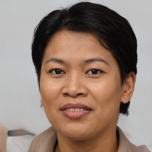 Joyful asian adult female with short  brown hair and brown eyes