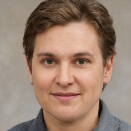 Joyful white adult male with short  brown hair and grey eyes