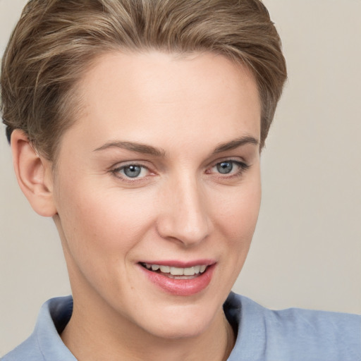 Joyful white young-adult female with short  brown hair and grey eyes