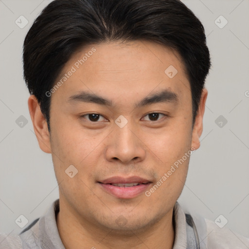 Joyful asian young-adult male with short  brown hair and brown eyes