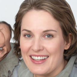 Joyful white adult female with medium  brown hair and blue eyes