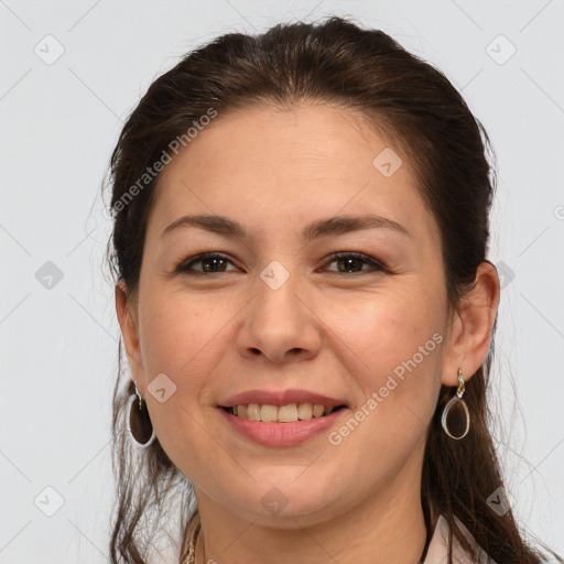 Joyful white young-adult female with long  brown hair and brown eyes