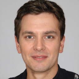 Joyful white adult male with short  brown hair and brown eyes