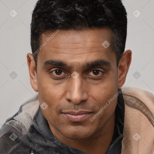 Joyful latino adult male with short  brown hair and brown eyes