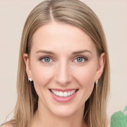 Joyful white young-adult female with long  brown hair and green eyes