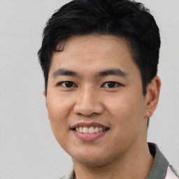 Joyful asian young-adult male with short  black hair and brown eyes