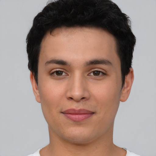 Joyful asian young-adult male with short  black hair and brown eyes