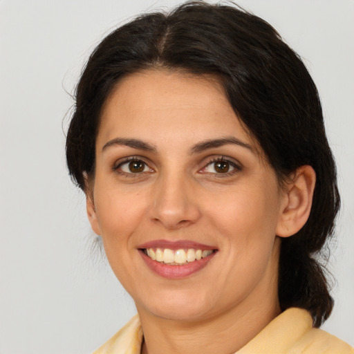 Joyful white young-adult female with medium  brown hair and brown eyes