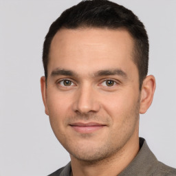 Joyful white young-adult male with short  brown hair and brown eyes