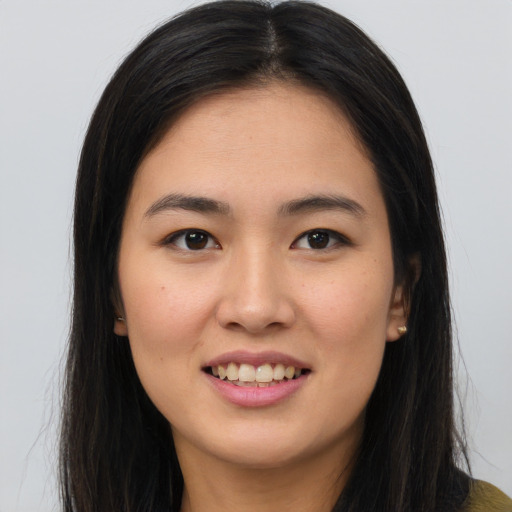 Joyful white young-adult female with long  brown hair and brown eyes