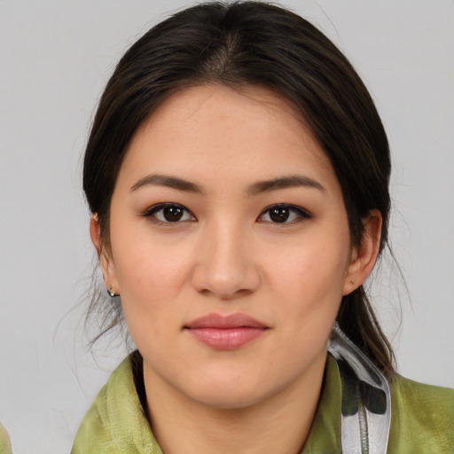Joyful latino young-adult female with medium  brown hair and brown eyes