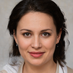 Joyful white adult female with medium  brown hair and brown eyes