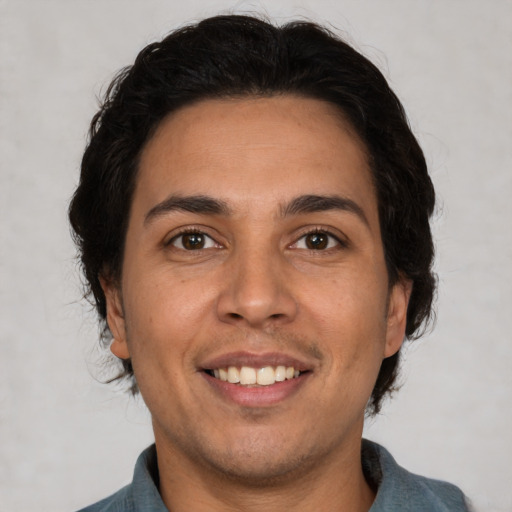 Joyful white adult male with short  brown hair and brown eyes