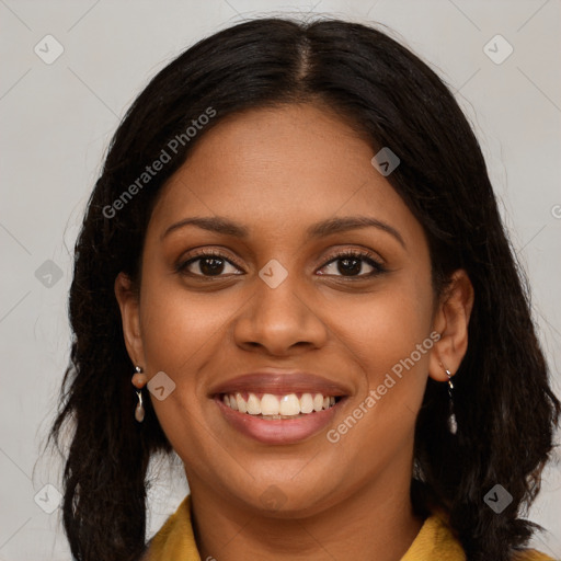 Joyful black young-adult female with long  brown hair and brown eyes