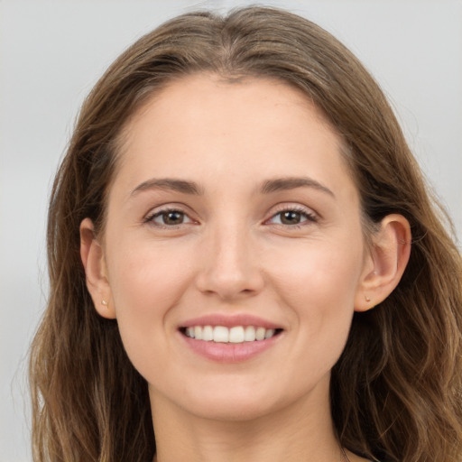 Joyful white young-adult female with long  brown hair and grey eyes