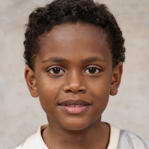 Joyful black child male with short  brown hair and brown eyes