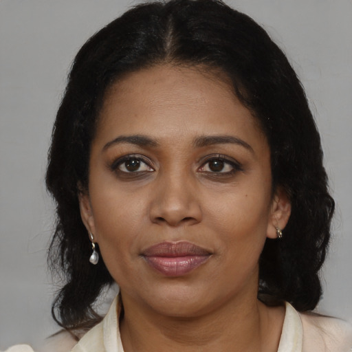 Joyful black young-adult female with medium  brown hair and brown eyes