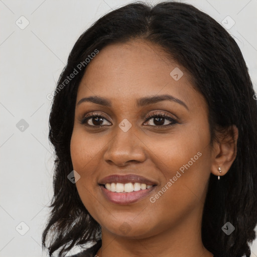 Joyful black young-adult female with long  brown hair and brown eyes