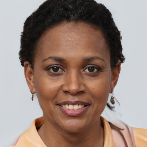 Joyful black adult female with short  brown hair and brown eyes