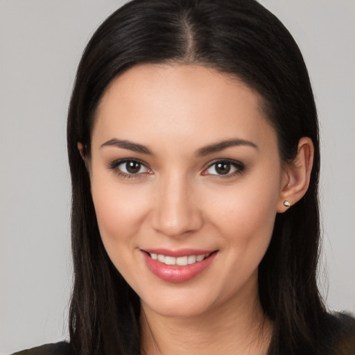 Joyful white young-adult female with long  black hair and brown eyes