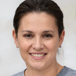 Joyful white adult female with medium  brown hair and brown eyes