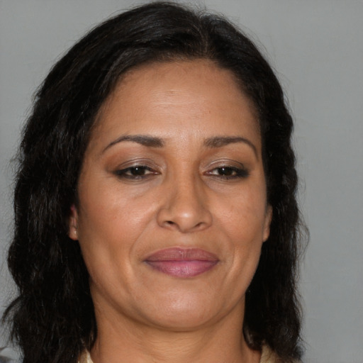 Joyful latino adult female with long  brown hair and brown eyes