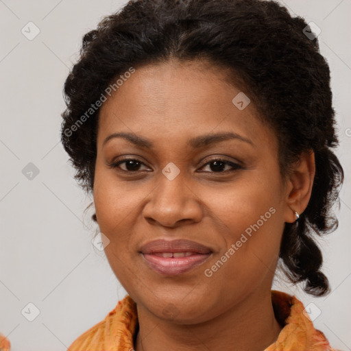 Joyful black adult female with medium  brown hair and brown eyes