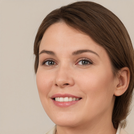 Joyful white young-adult female with medium  brown hair and brown eyes