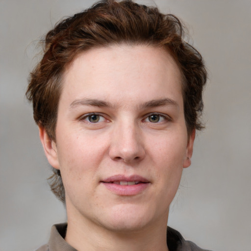 Joyful white young-adult female with short  brown hair and grey eyes