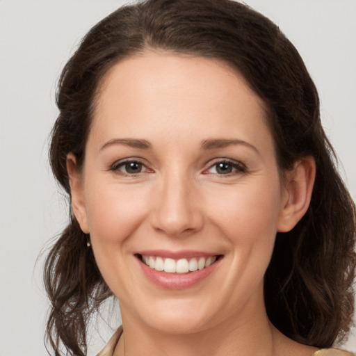 Joyful white young-adult female with medium  brown hair and brown eyes