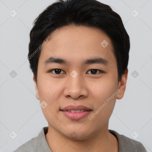 Joyful asian young-adult male with short  black hair and brown eyes